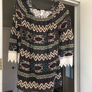 Aztec style shirt with lace bottom sleeves.